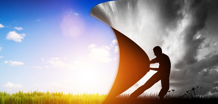 Photo of a man peeling back a black and white background to reveal a full color background