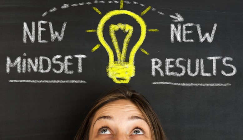 Photo of a person's head with a light bulb drawn above it. The words "new mindset, new results" are written next to the light bulb