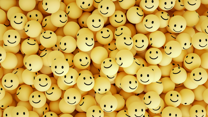 A bunch of yellow ping pong balls with smiley faces on them